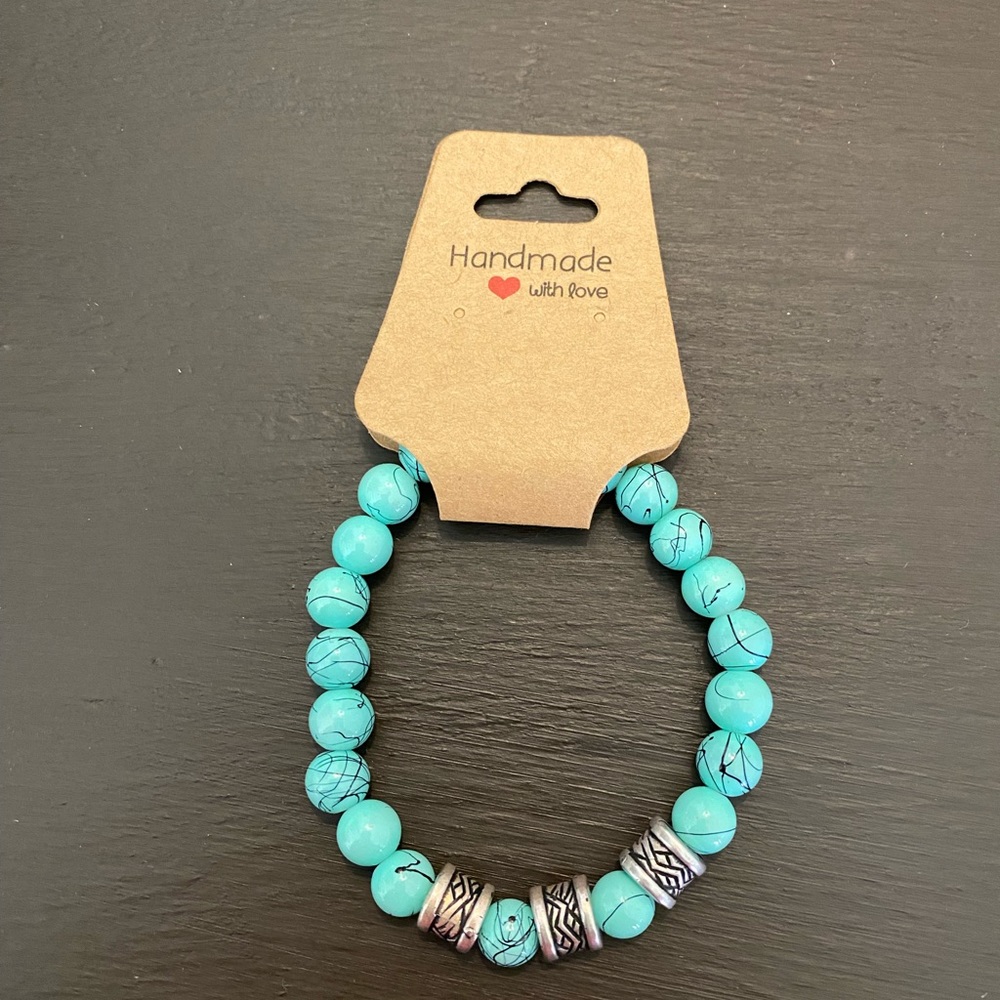Brand new, never worn, original turquoise with silver accents, stretch bracelet